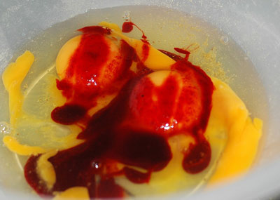 Red-Liquid-is-added-to-eggs