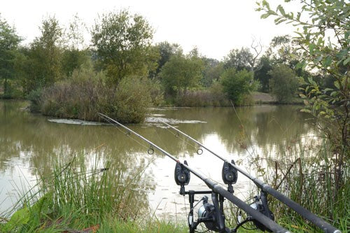 Smaller carp lake with two rods awaiting a catch.