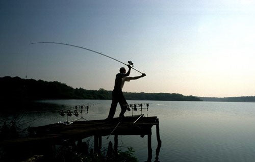 Silhouette of a man and a large rod.
