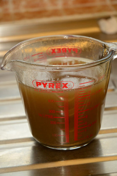 Stir-to-dissolve-the-sugar-and-then-strain-the-liquor-into-a-measuring-jug
