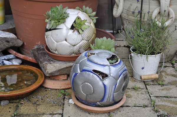 Footballs that have been used as planters.