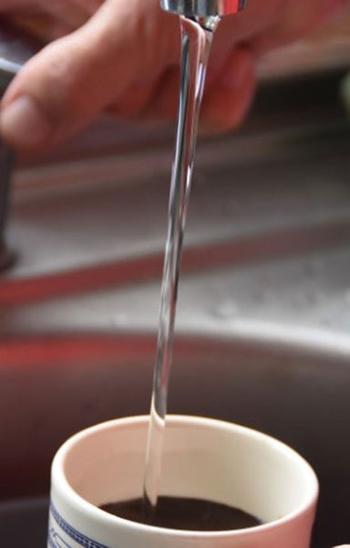 Water being poured into a mug.