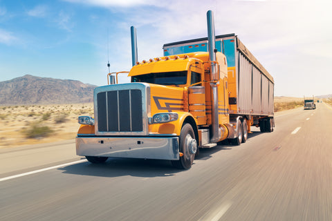 big orange truck on the speed way