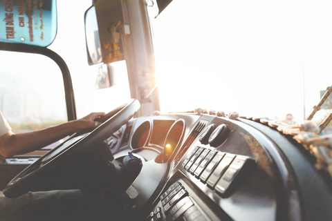 Closeup view of the hands of truck driver who is holding the steering wheel