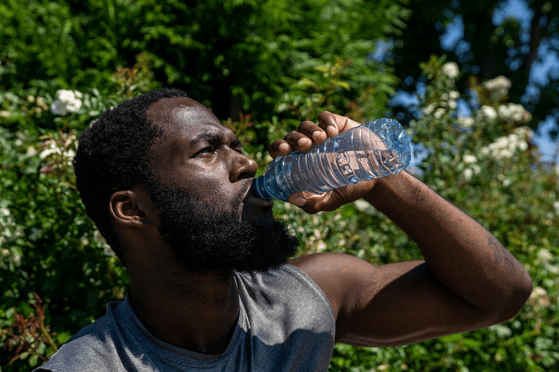 man drinking from water bottle