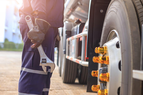 Mechanic with Large Wrench in Hand Taking Look at on the Truck,Concept truck maintenance,spot focus.