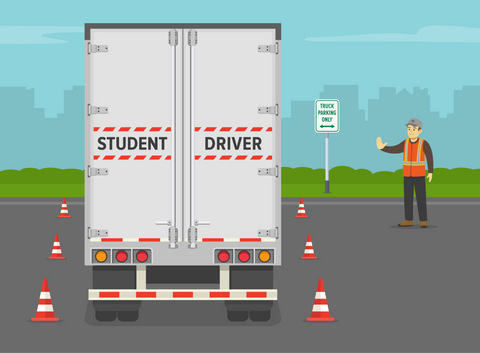 Student driver driving a truck. Instructor makes a stop gesture with his hand.