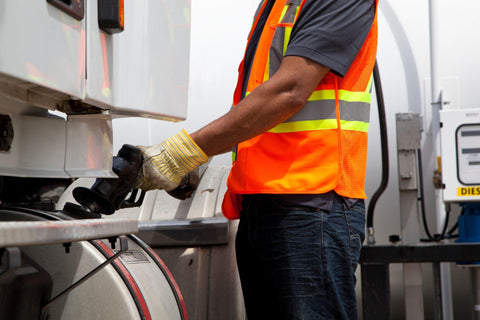 Truck driver refuelling transport truck