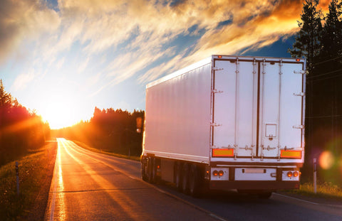 White truck on the asphalt road in the evening