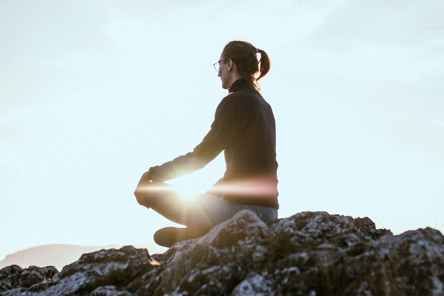 Woman sitting on rock