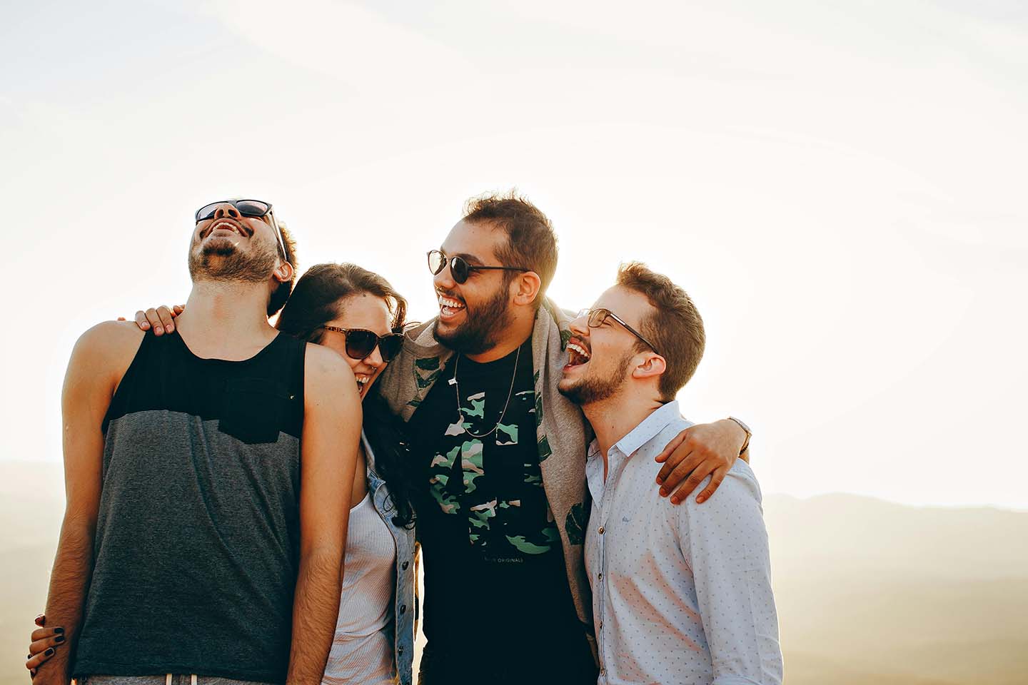 Group of four friends laughing