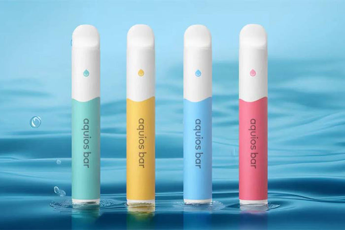 Four Aquios Bar nicotine free vape devices on water.