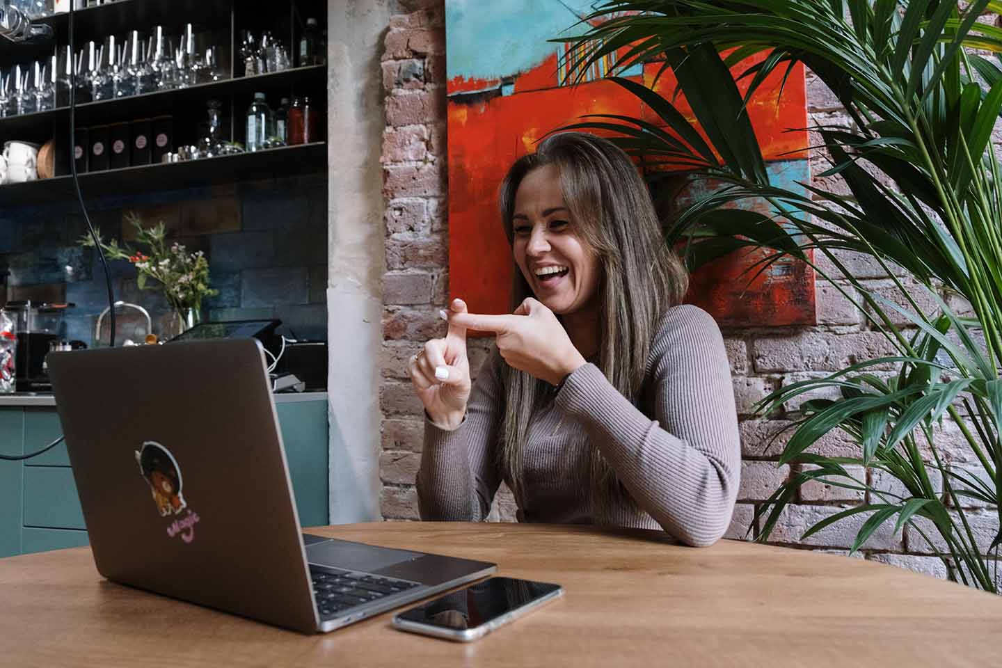 Woman smiling in front of laptop