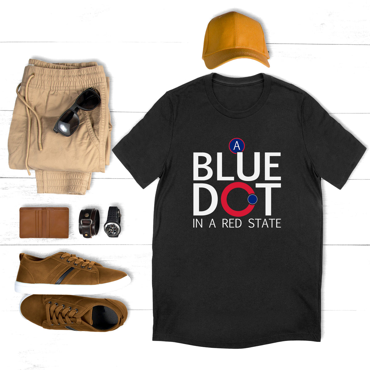 Black unisex t-shirt with text that reads “A Blue Dot in a Red State.”