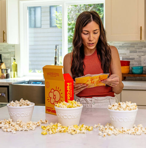 woman reads the instructions for making Popsmith's Oh Sooo Buttery Popcorn