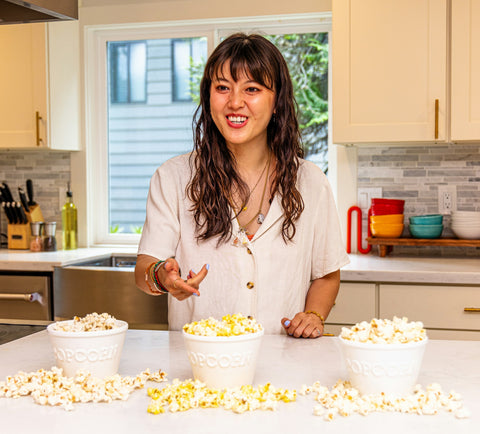Woman points at bowl of popcorn