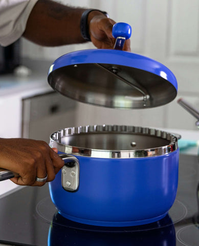 Man takes off the lid of a cobalt popcorn popper