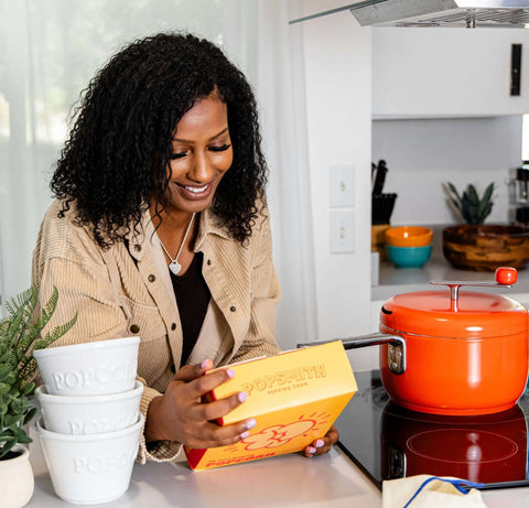 woman reads label of a box of Oh Sooo Buttery Popcorn