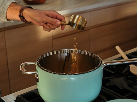 Person pours kernels into a mint Popsmith popper