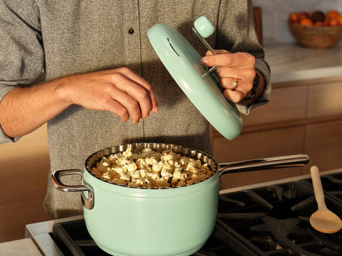 Man adds seasoning to popcorn