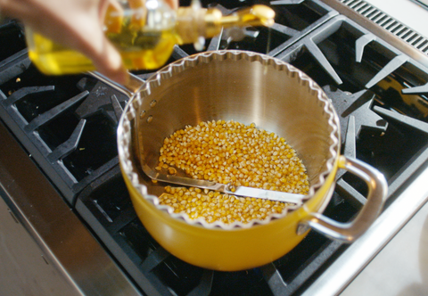 Woman pours oil into Popper