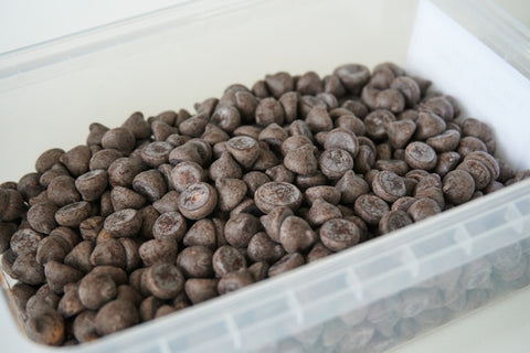 chocolate chips in a white plastic container