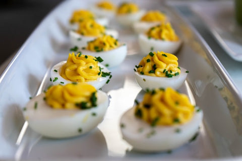 deviled eggs topped with chives