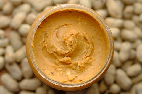 an open jar of creamy peanut butter