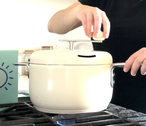 woman turns crank of cream colored Popsmith popper