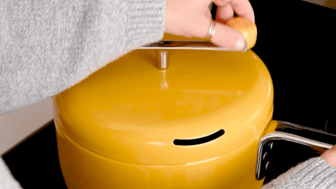 Woman turns crank of butter colored Popper