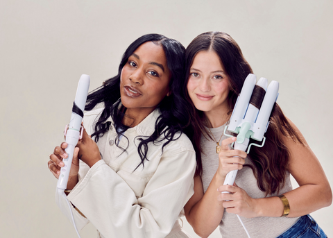 Two brunette women holding Mane's Jumbo Hair Waver and 1.25” Curling Wand Styling Attachment