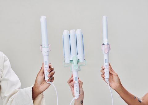 Three hands holding Mane's Power Bottom Bases with 1.25” Curling Wand Styling Attachment, 1.25” Jumbo Hair Waver Styling Attachment, and 1” Curling Iron Styling Attachment