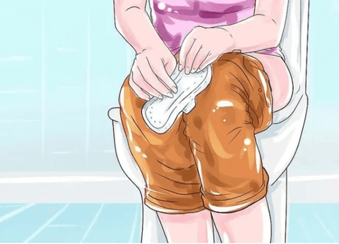 Girl squatting on toilet with sanitary napkin