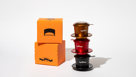 Nam Coffee's phin filter in copper, red, and black