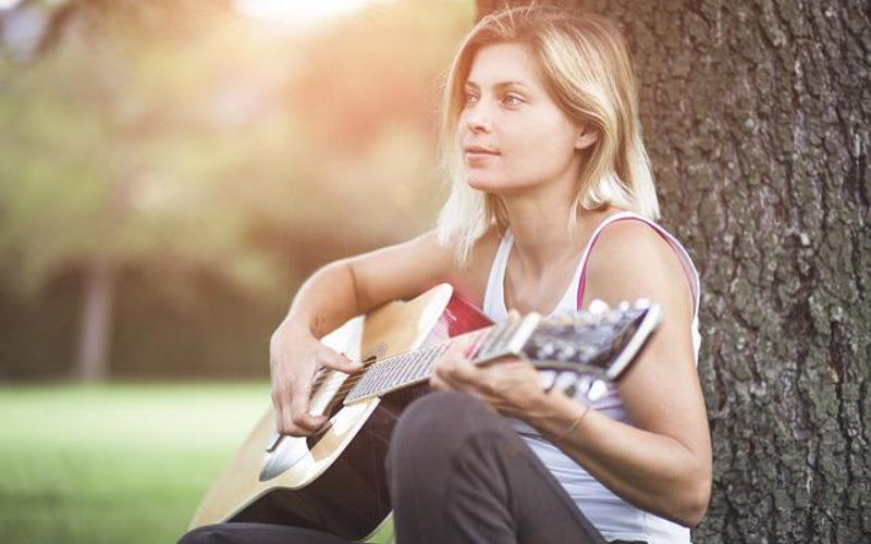 Artist Writing Song With Guitar