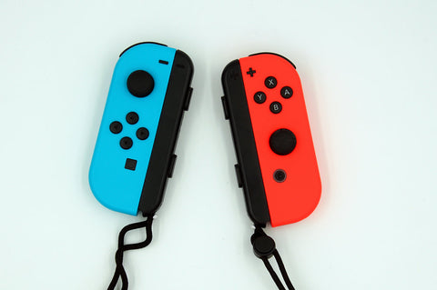 Red and blue Nintendo Switch Joy-con controllers against a white background