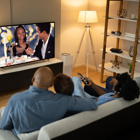 a family watching a movie together on a couch