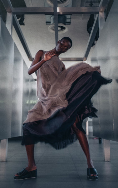 model dancing in grey dress playful