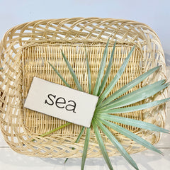 coastal basket with anchored soul sign and palm branch, decorating coastal style on a budget