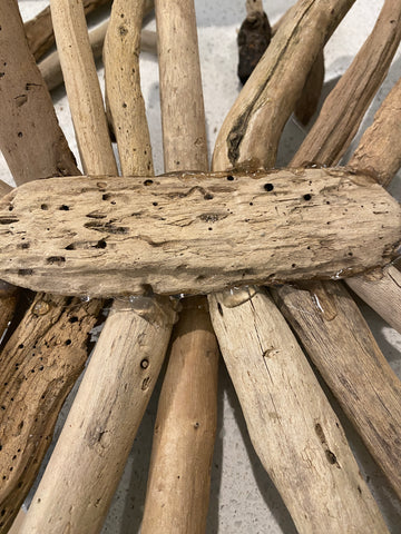 Hot gluing driftwood together for a starburst tree topper