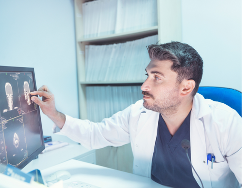 Radiologist checking imaging exam on computer