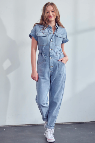 A model in a stylish denim jumpsuit that is perfect for work