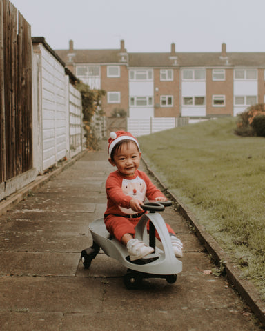 Little boy riding Grey Didicar Christmas gift