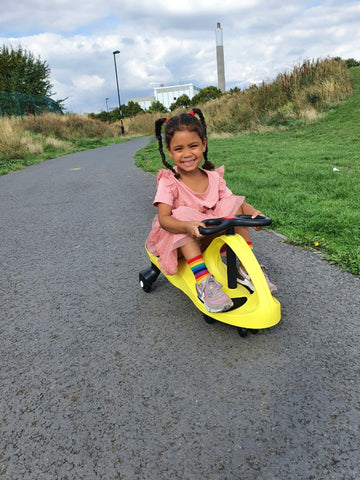 Girl riding her Yellow Didicar