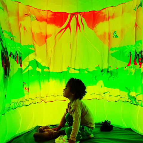 child playing inside sensory dinosaur themed POD