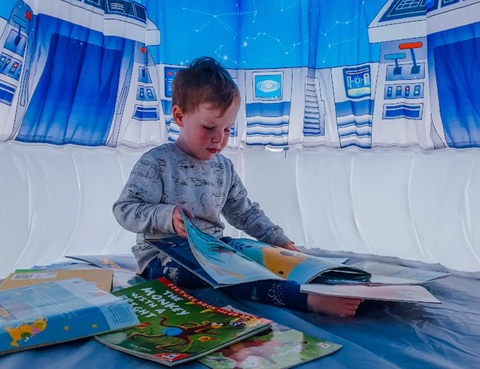 child reading inside pod