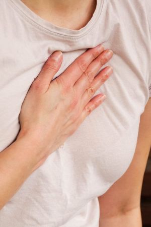 Woman holding chest