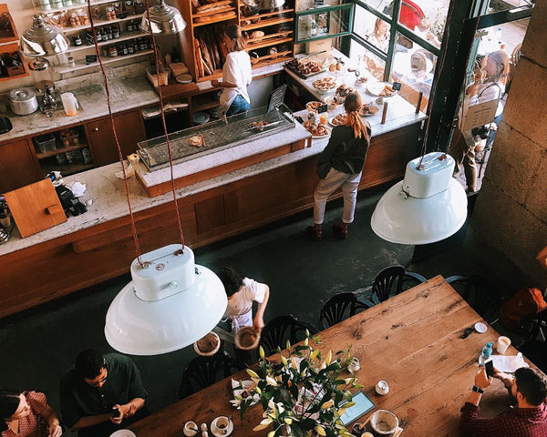 A scene of people visiting a coffee roaster in Perth and enjoying coffee and chatting