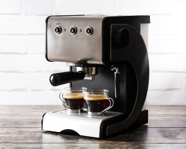 Coffee machine with Dark roasted coffee beans made into an espresso coffee.jpg