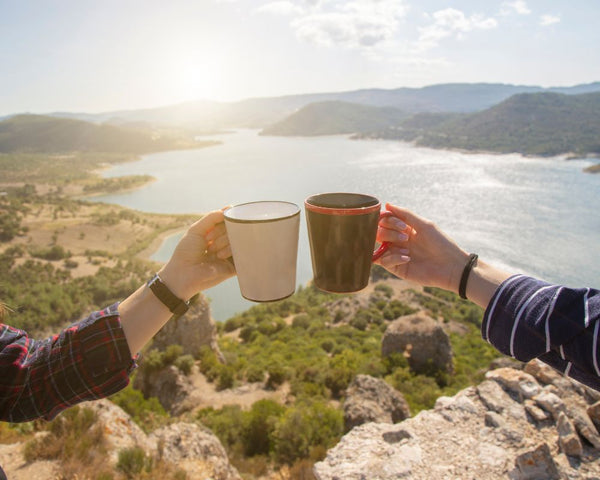 Scenic image of 2 people holding coffee implying that they have joined the adventure to discover the best coffee roasters in Perth